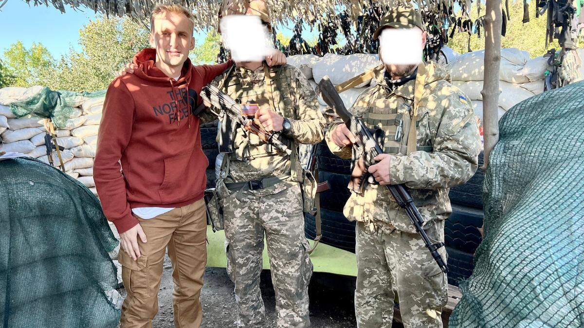 University of Washington Tacoma grad David Pavenko pictured with Ukrainian soldiers near the city of Avdiivka in October 2022, during his first trip to deliver aid in the country. Pavenko will return to Ukraine this week, missing UWT’s commencement in the process.