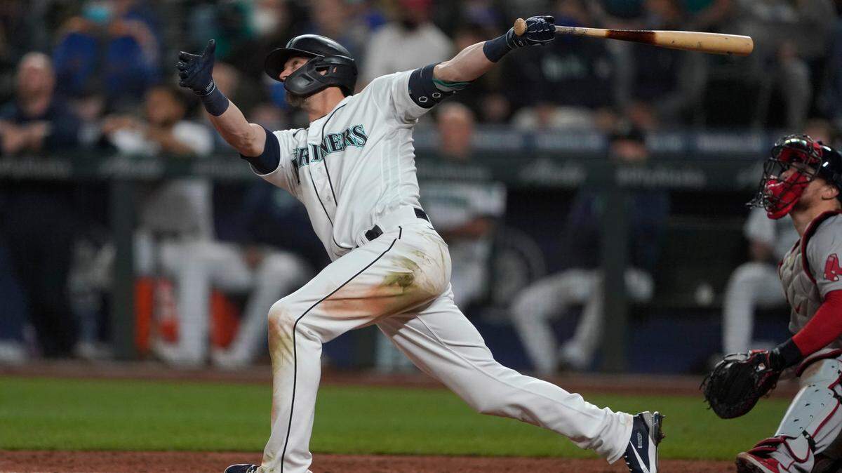 Seattle Mariners’ Mitch Haniger follows through on a three-run go-ahead home run against the Boston Red Sox during the seventh inning of a baseball game, Monday, Sept. 13, 2021, in Seattle. (AP Photo/Ted S. Warren)