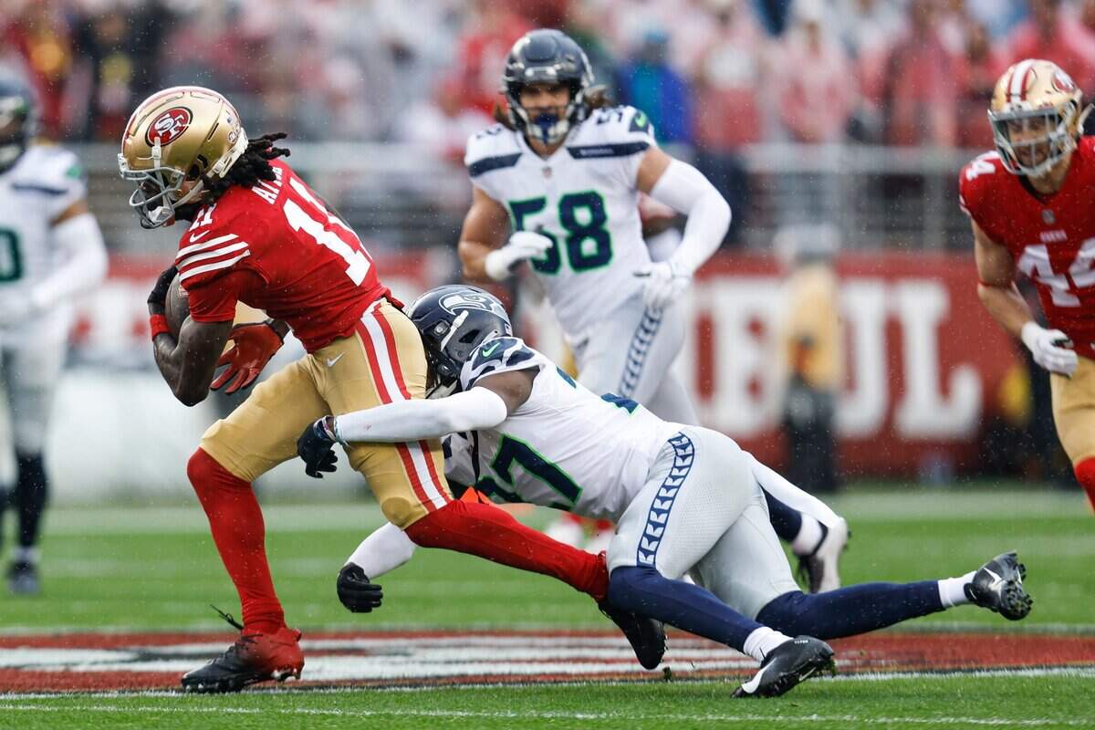 San Francisco 49ers wide receiver Brandon Aiyuk (11) runs against Seattle Seahawks cornerback Tariq Woolen (27) during the first half of an NFL wild card playoff football game in Santa Clara, Calif., Saturday, Jan. 14, 2023. (AP Photo/Jed Jacobsohn)