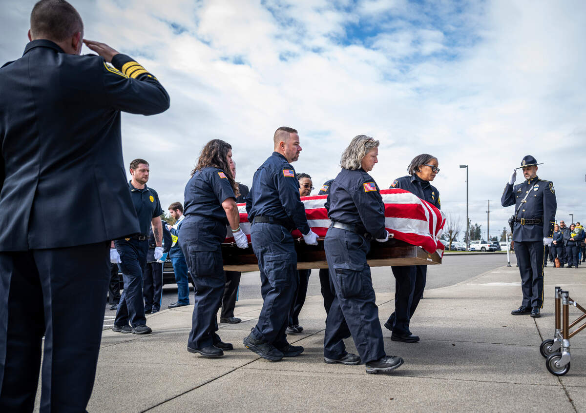 Pallbearers Anthony Hinz, Denelle Ruffner, Julianna Seiple, Kenneth Bohocky, Kiesha Channel, Deen Hanson, Kay Coleman and Michael McCready carry their friend and co-worker Jay Miller, a former corrections officer at the Washington Corrections Center For Women, into the Church for All Nations for his memorial service in Parkland, Wash. Feb. 22, 2023. Miller worked for the Department of Corrections for 30 years and passed away at the age of 56, from COVID-19 complications.