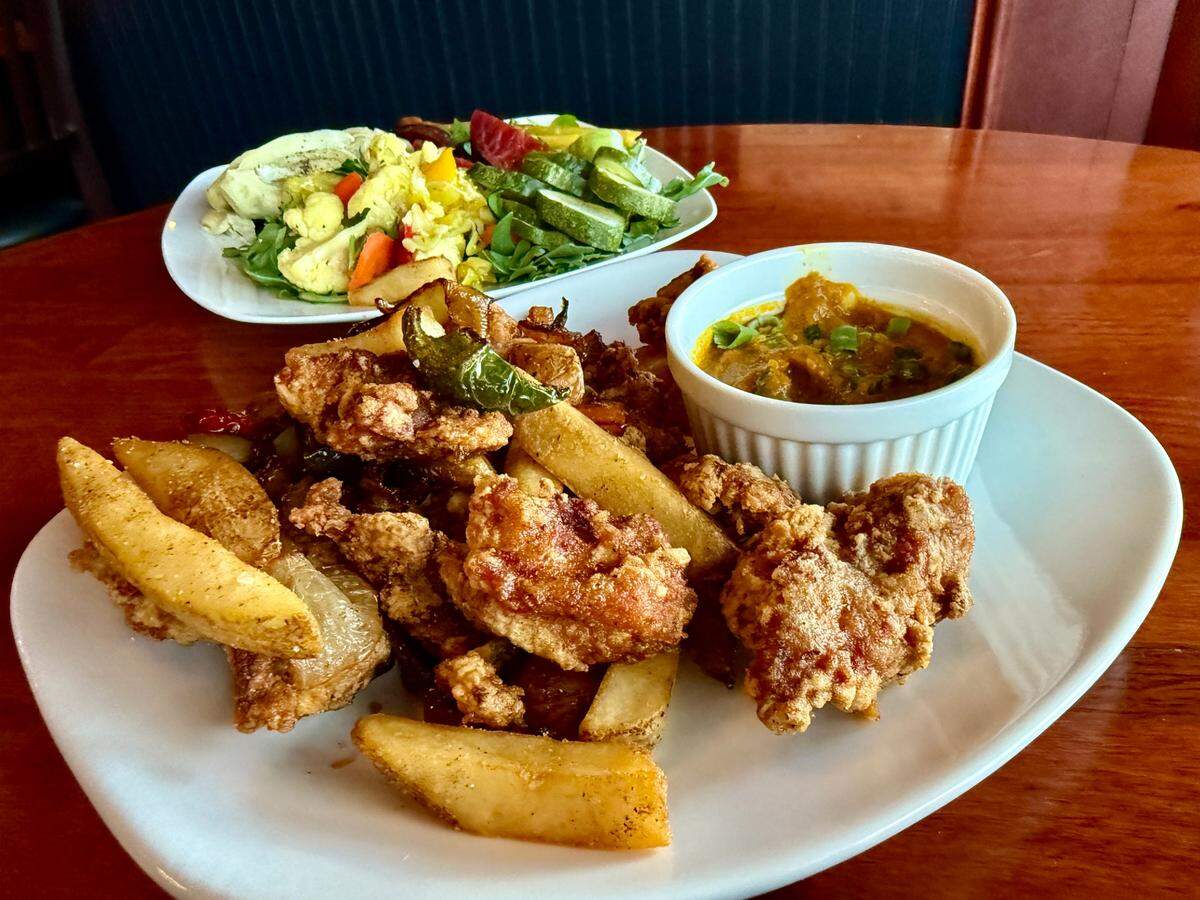 The spice bag, shown here out of its paper bag serving vessel, combines fried nubs with grilled onions and peppers, all heavily spiced. Shake or dip into your choice of curry or sweet’n’sour sauce.