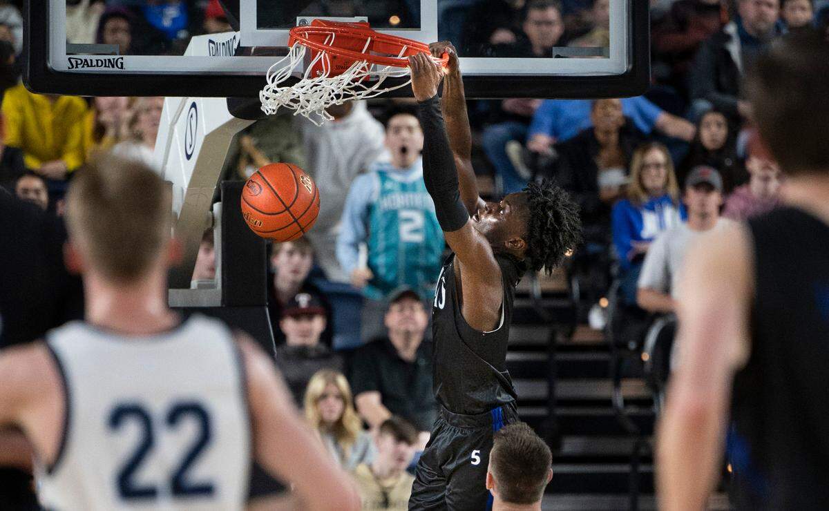 Curtis’ Zoom Diallo throws down a monster dunk during the 4A boys state title game against the OIympia Bears at the WIAA state basketball tournament in the Tacoma Dome in Tacoma, Washington, on Saturday, March 4, 2023. Curtis won the game, 49-43.