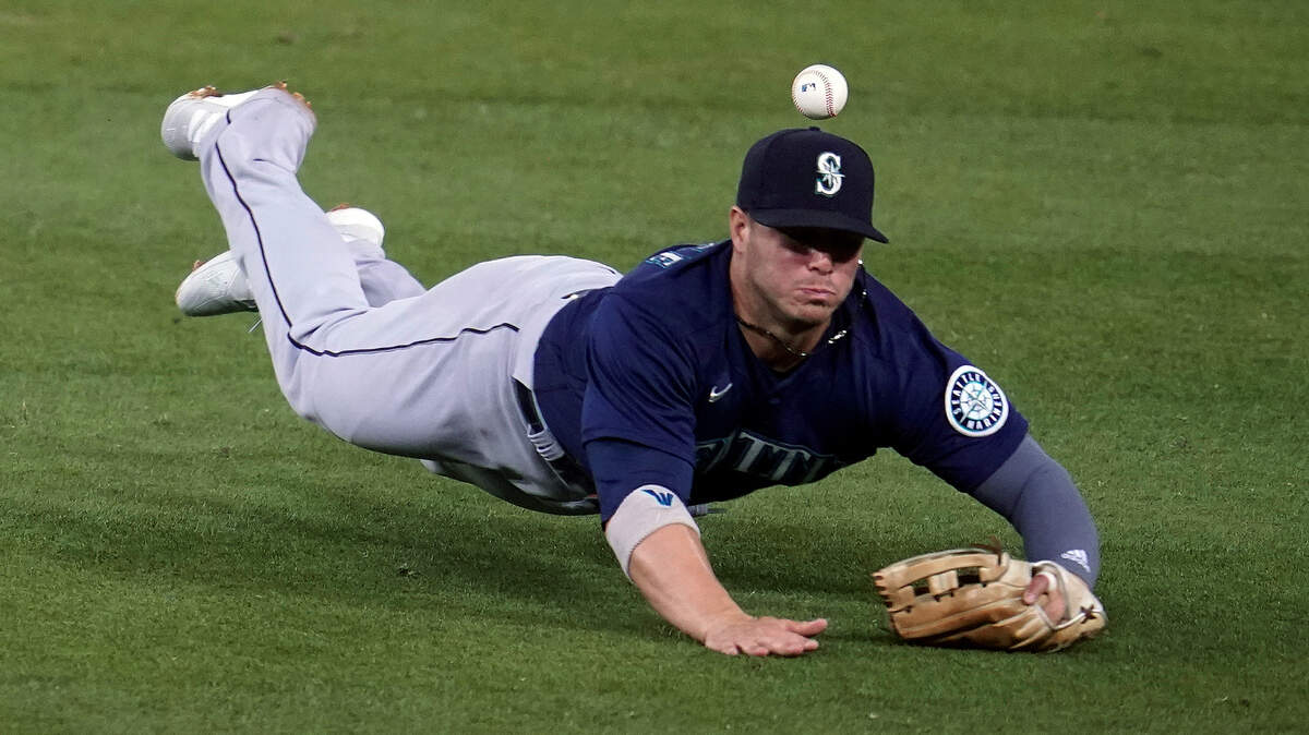 Seattle Mariners second baseman Ty France dives for but can’t catch a fly ball hit by Los Angeles Dodgers’ Will Smith during the fourth inning of a baseball game Wednesday, May 12, 2021, in Los Angeles. Smith singled on the play. (AP Photo/Marcio Jose Sanchez)