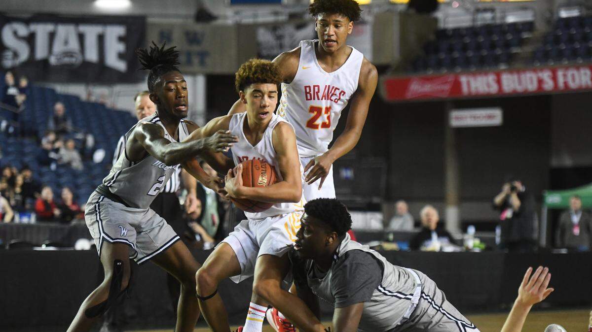 Kamiakin boys beat visiting Walla Walla 78-46 this week. Shown are Braves players fighting for a loose ball during the Hardwood Classic at the Tacoma Dome in March 7, 2020. (File photo)