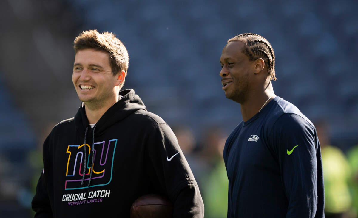 Former Seattle Seahawks and current New York Giants quarterback Drew Lock talks with former teammate =Seattle Seahawks quarterback Geno Smith (7) before the game between the Seattle Seahawks and the New York Giants at Lumen Field, on Sunday, Oct. 6, 2024 in Seattle, Wash.