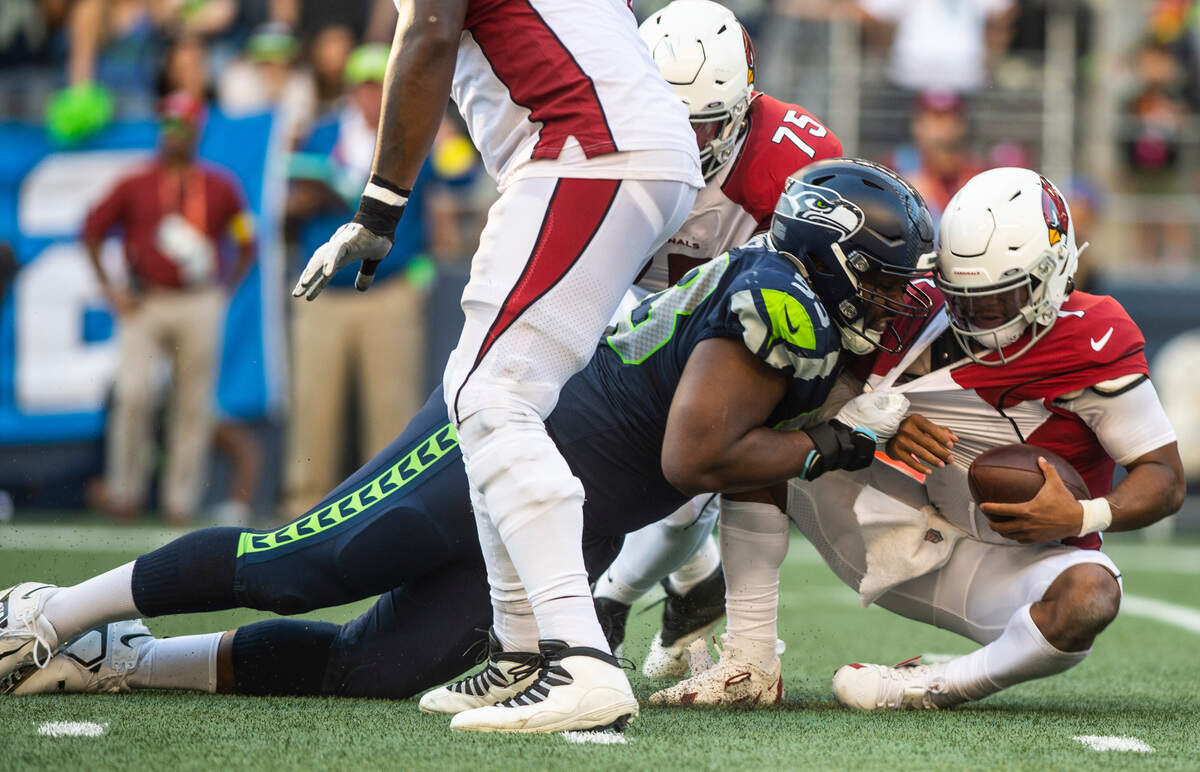 Seattle Seahawks defensive end Shelby Harris (93) tackles Arizona Cardinals quarterback Kyler Murray (1) in the fourth quarter of an NFL game on Sunday, Oct. 16, 2022, at Lumen Field in Seattle.