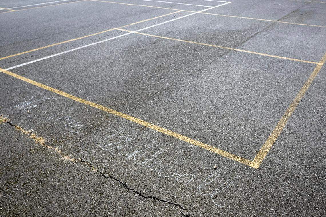 A chalked message of “we love pickleball,” runs along the side of the lines for a pickleball court on Tuesday, May 6, 2025, at Jefferson Park in Tacoma, Wash.