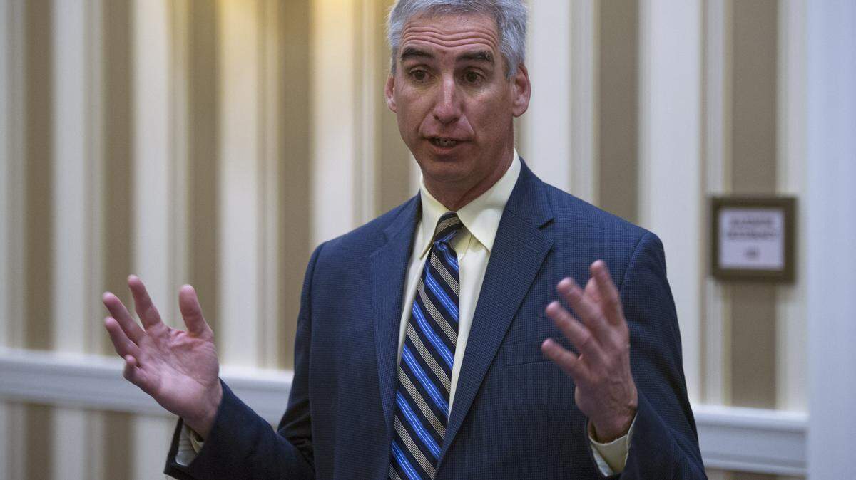 Oliver Luck speaks with members of the media at the NCAA Convention in Oxon, Md., Friday, Jan. 16, 2015. Former West Virginia athletic director and selection committee member Oliver Luck says the College Football Playoff should stay at four. Now with the NCAA, Luck says it should be hard to get into the playoff. (AP Photo/Cliff Owen)