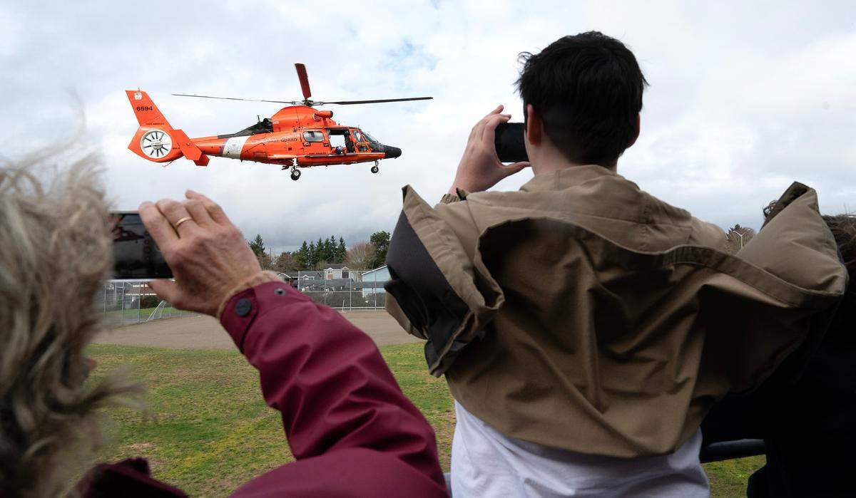 A Coast Guard Dolphin MH-65E rescue helicopter lands at Truman Middle School in Tacoma, Washington, on Thursday, Feb. 15, 2023.