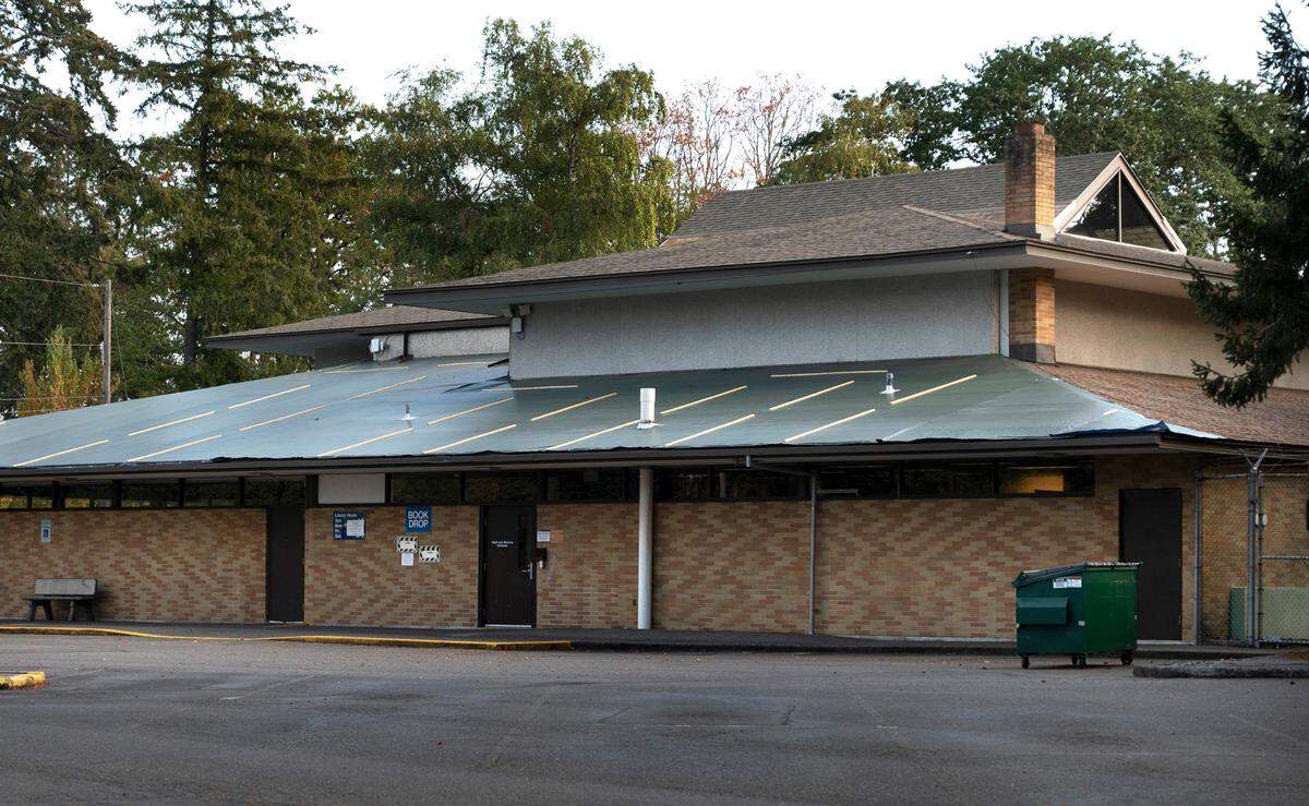 Tarps cover portions of the roof of the Lakewood Pierce County Library in Lakewood, Washington, which has been closed since June due to the need for major repairs. The building is shown on Saturday, Sept. 24, 2022.