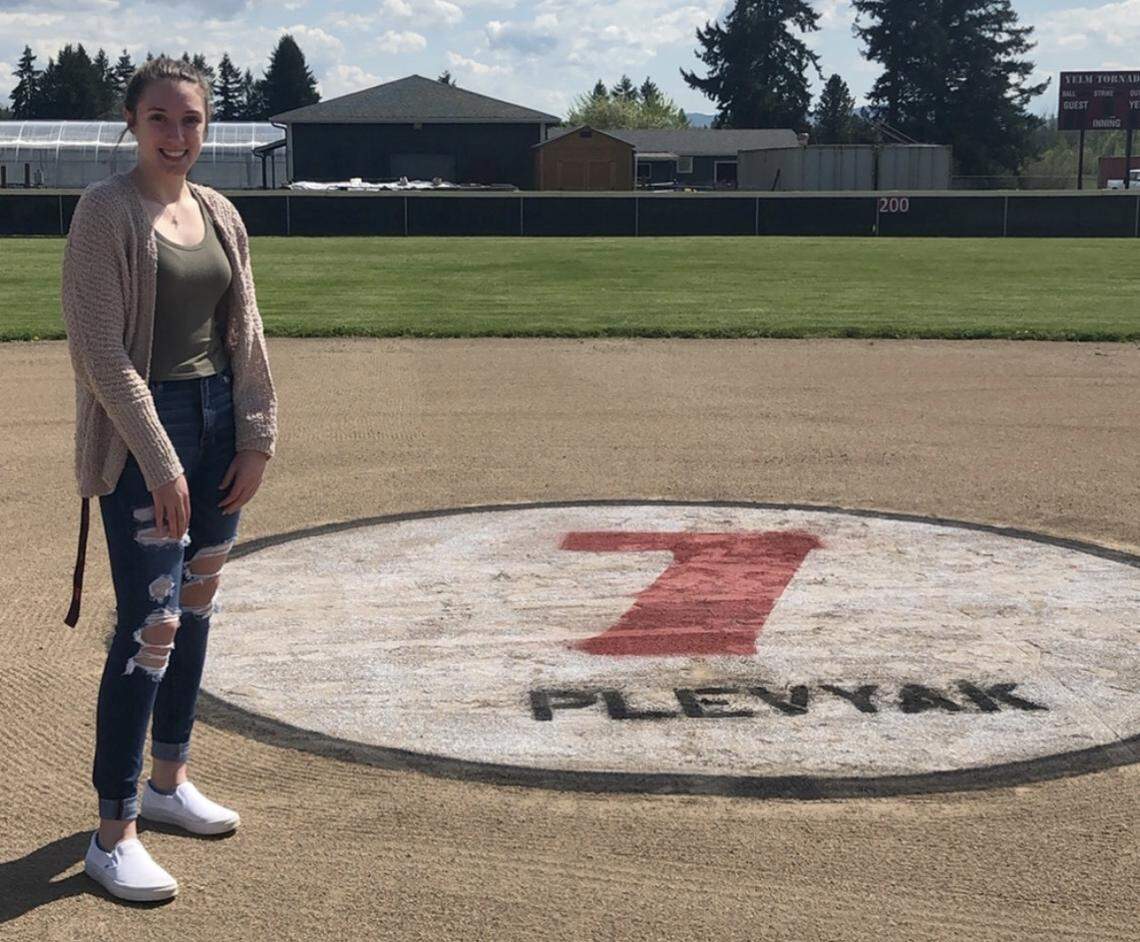 Yelm High Schoo graduate Maddie Plevyak stands next to a patch of infield with her name painted in after her senior season was wiped away by the coronavirus pandemic.