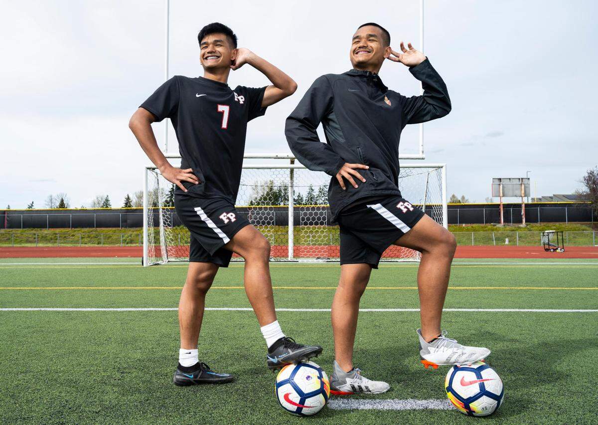Franklin Pierce High School sophomore twin brothers Preston Soeum, left, and Marvin Soeum pose for a portrait on the soccer field at Franklin Pierce High School in Tacoma, Wash. on Monday, April 11, 2022. The brothers have the Cardinals sitting in first place in the 2A SPSL.