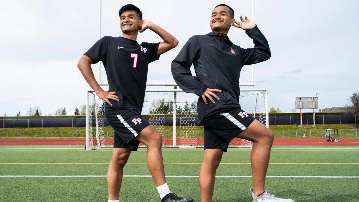 Franklin Pierce High School sophomore twin brothers Preston Soeum, left, and Marvin Soeum pose for a portrait on the soccer field at Franklin Pierce High School in Tacoma, Wash. on Monday, April 11, 2022. The brothers have the Cardinals sitting in first place in the 2A SPSL.