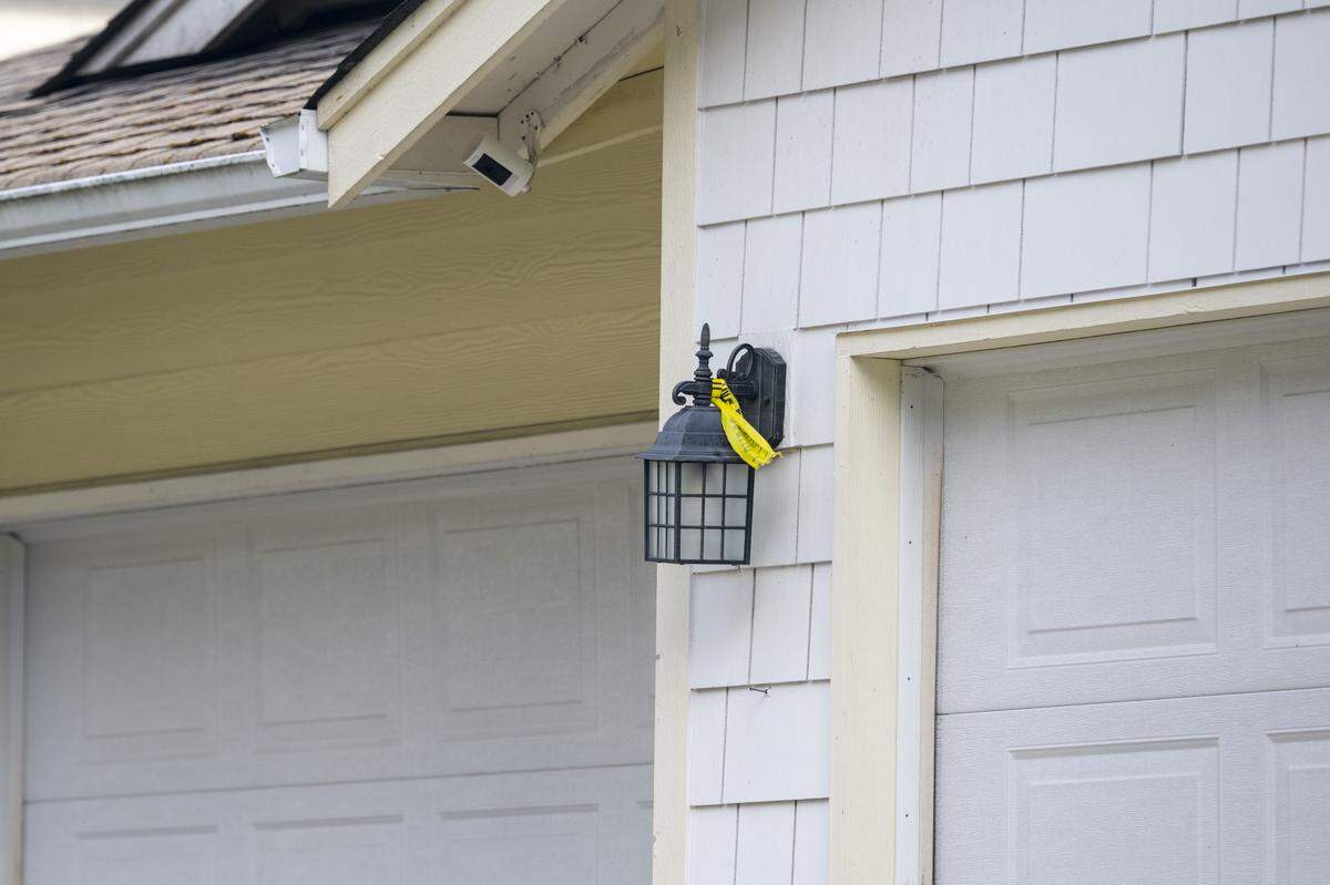 Remains of police tape are visible on the 14000 block of 87th Avenue Court Northwest on Wednesday, Feb. 25, 2026, on the Key Peninsula.