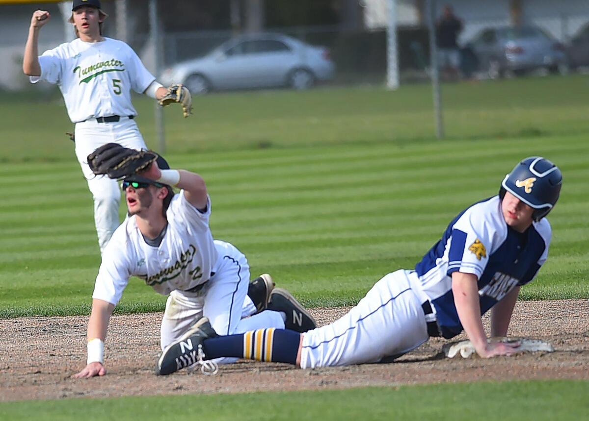 Tumwater shortstop Eddie Marson shows his glove to the umpire after tagging out an Aberdeen baserunner as the T-Birds hosted the visiting Bobcats in a 2A Evergreen league contest on Thursday, April 7.