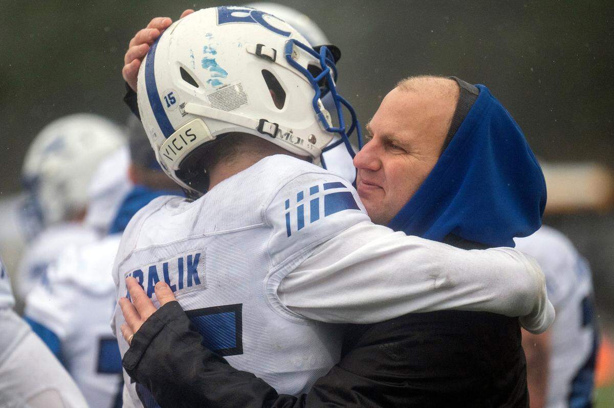 Eatonville head coach Gavin Kralik hugs his son and junior wide receiver Job Kralik (15) after the Cruisers fell to Royal, 41-0, in the State 1A championship game on Saturday afternoon at Harry E. Lang Stadium in Lakewood.