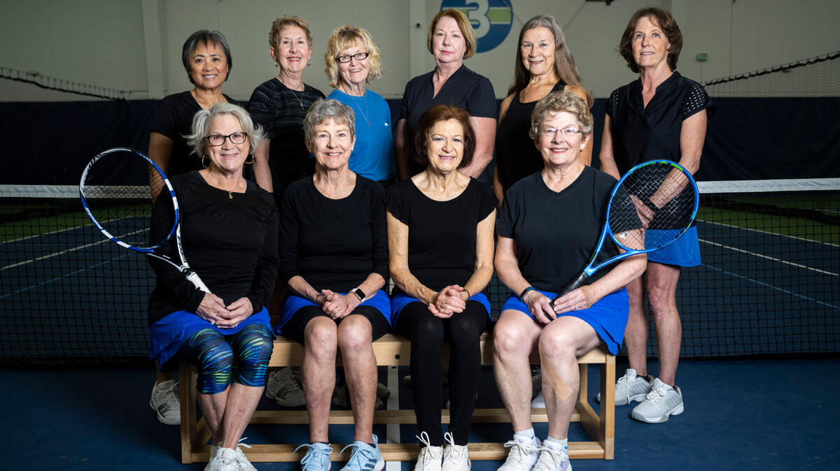 Back row from left, Jacqueline deLeon, Cindy Skinner, Barb Van Sickle, Kathy Heinz, Kathy Shouse, Casey Hunter and front row from left, Kelly Compton, co-captain Pat O’Donnell , co-captain Mary Souza, Marsha White and Cassy Sparks (not pictured) pose for a photograph as members of “Team PNW,” a local tennis team of women 65 and older, at the Galbraith Tennis Center in Tacoma, Wash. on Jan. 26, 2023. The team qualified for the USTA League’s 65 & Over Invitational in Surprise, Arizona for the first time and will compete twice in the tournament.