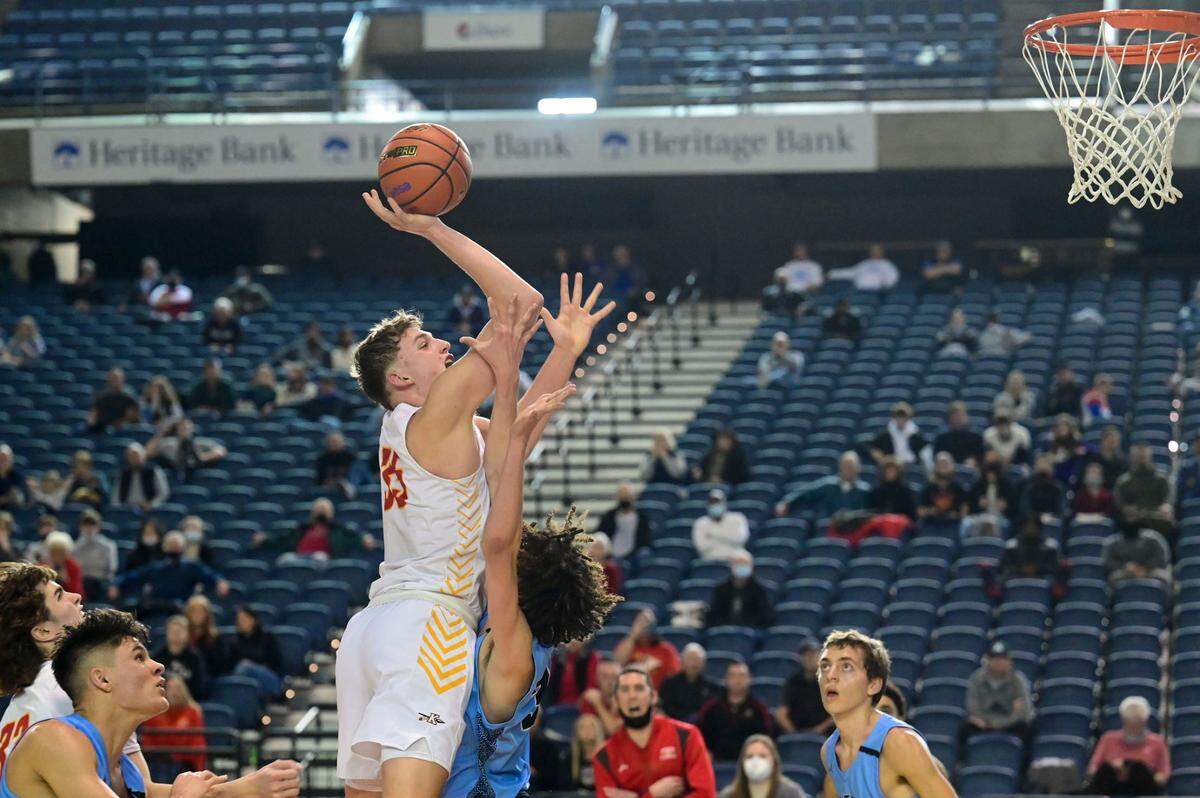 Kamiakin forward Tyler Bilodeau (35) attempts a shot as Central Valley guard Daniel Crowley (32) defends during the fourth quarter of a Class 4A state tournament game on Wednesday, March 2, 2022, at the Tacoma Dome, in Tacoma, Wash.