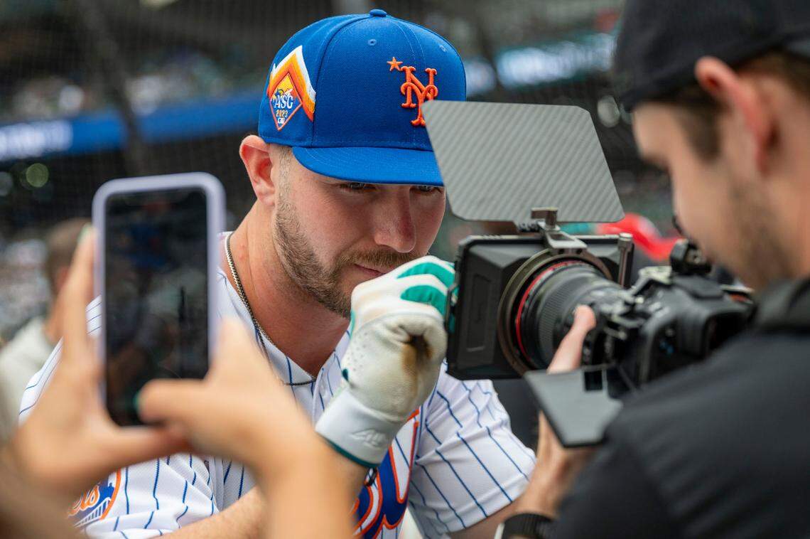 New York Mets first baseman Pete Alonso signs a camera lens after taking batting practice prior to the start of the 2023 MLB Home Run Derby on Monday, July 10, 2023, at T-Mobile Park in Seattle.