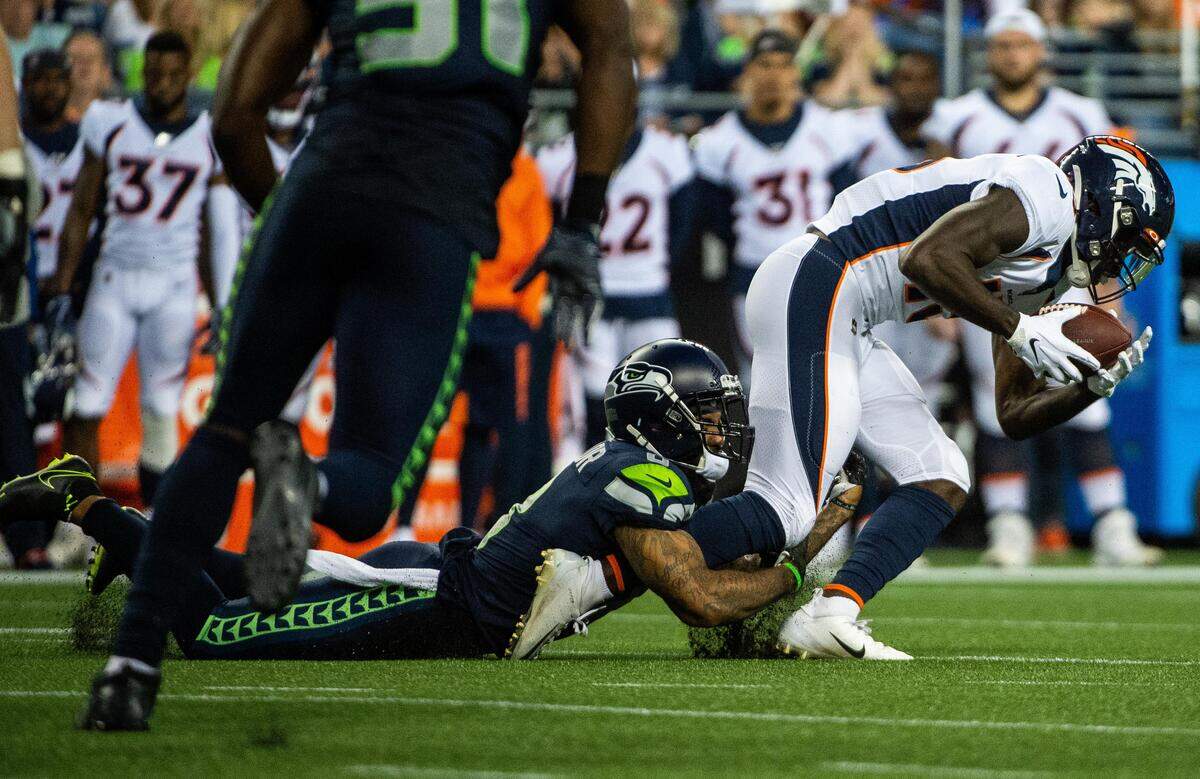 Seattle Seahawks cornerback Jamar Taylor (8) tackles Denver Broncos wide receiver Kelvin McKnight (16) during their preseason game. The Seattle Seahawks played the Denver Broncos in a NFL preseason game at CenturyLink Field in Seattle, Wash., on Thursday, Aug. 8, 2019.
