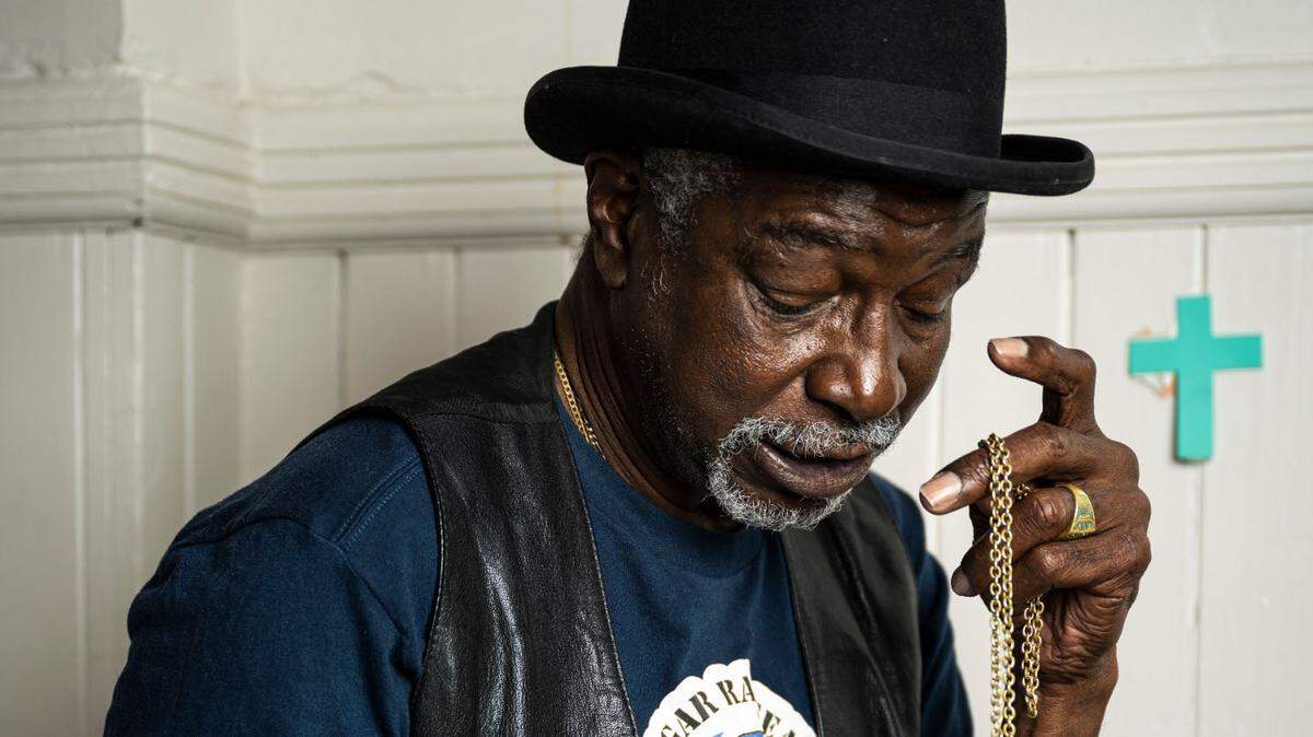 1972 Olympic gold medalist Sugar Ray Seales sits on a bed in Shiloh Baptist Church in Tacoma, Wash. on March 29, 2023. Seales fell into homelessness after returning to Tacoma after the death of his wife. This week, Seales moved into a new apartment.