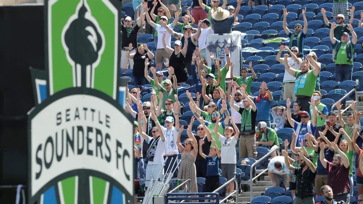 Seattle Sounders supporters cheer at the start of an MLS soccer match against New York City, Sunday, July 29, 2018, in Seattle. (AP Photo/Ted S. Warren)