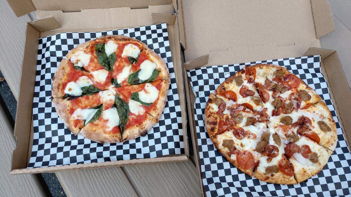 A MamaRita pizza (left) and the Fat Zach with five kinds of pork toppings from Fat Zach’s Wood Fire Pizza in Puyallup.