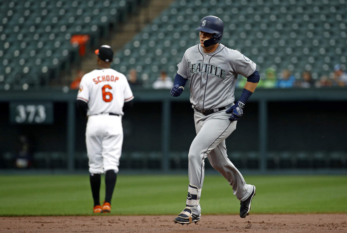 Seattle Mariners' Ryon Healy rounds the bases past Baltimore Orioles second baseman Jonathan Schoop after hitting a solo home run during the second inning of a baseball game Wednesday, June 27, 2018, in Baltimore. (AP Photo/Patrick Semansky)