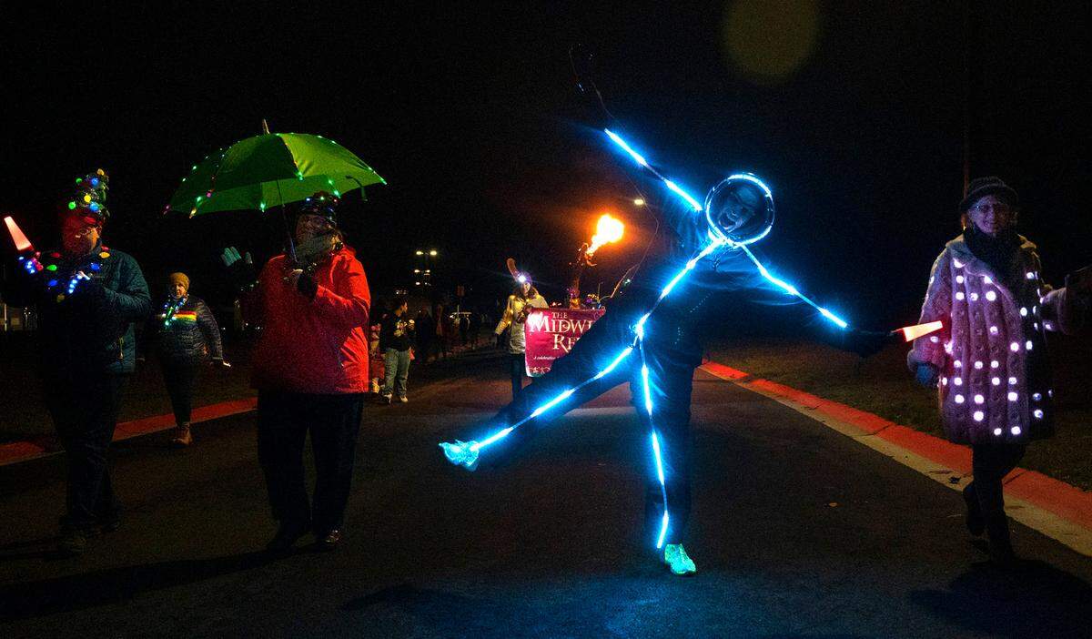Matt Oberfield of Tacoma leads a colorful and musical light parade through the neighborhoods around Boze Elementary School in Tacoma, Washington, as part of the Tacoma Light Trail preview on Wednesday, Dec. 7, 2022.