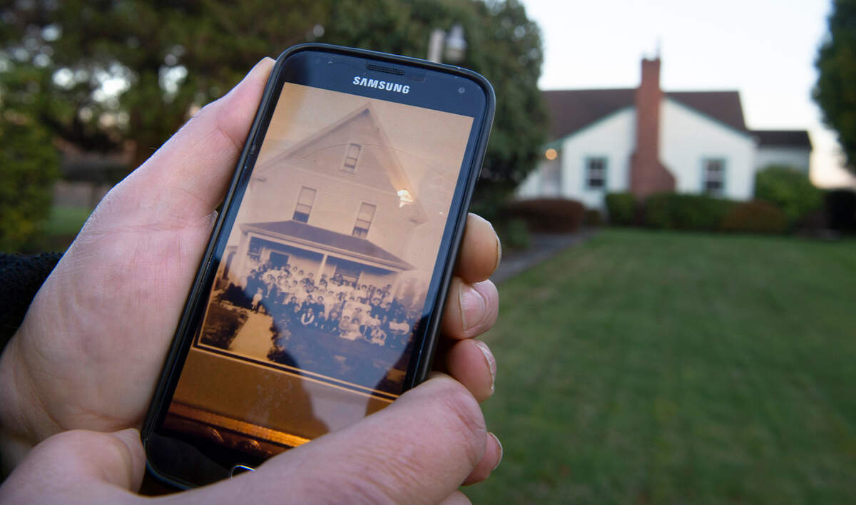 Steve Asbjornsen shows a historic photo of the home that previously sat on his family’s property along 82nd Avenue East in Pierce County north of Puyallup on Tuesday, Dec. 1, 2020.