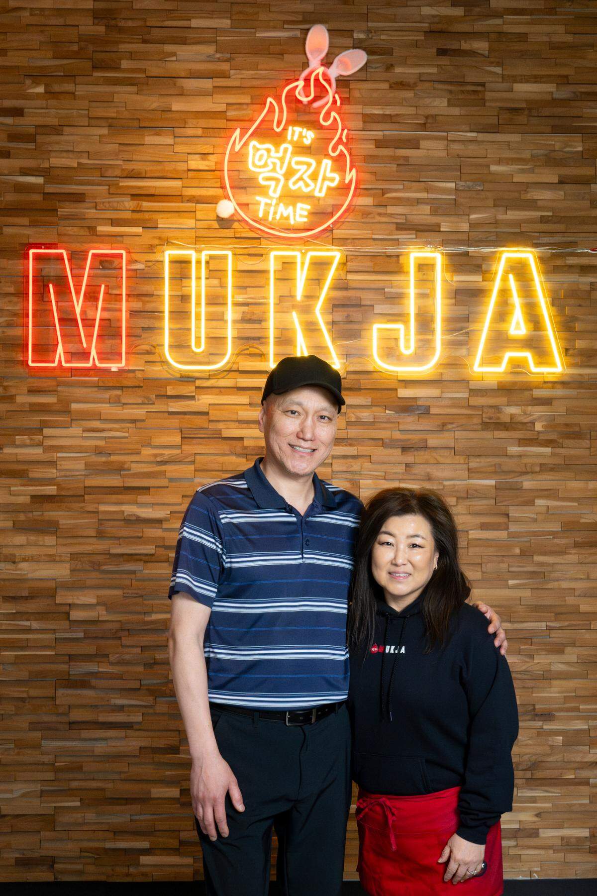 Husband and wife John Yi and Lisa Yi, owners of Mukja Korean BBQ, pose for a portrait at the restaurant on Friday, April 18, 2025, in Puyallup, Wash.