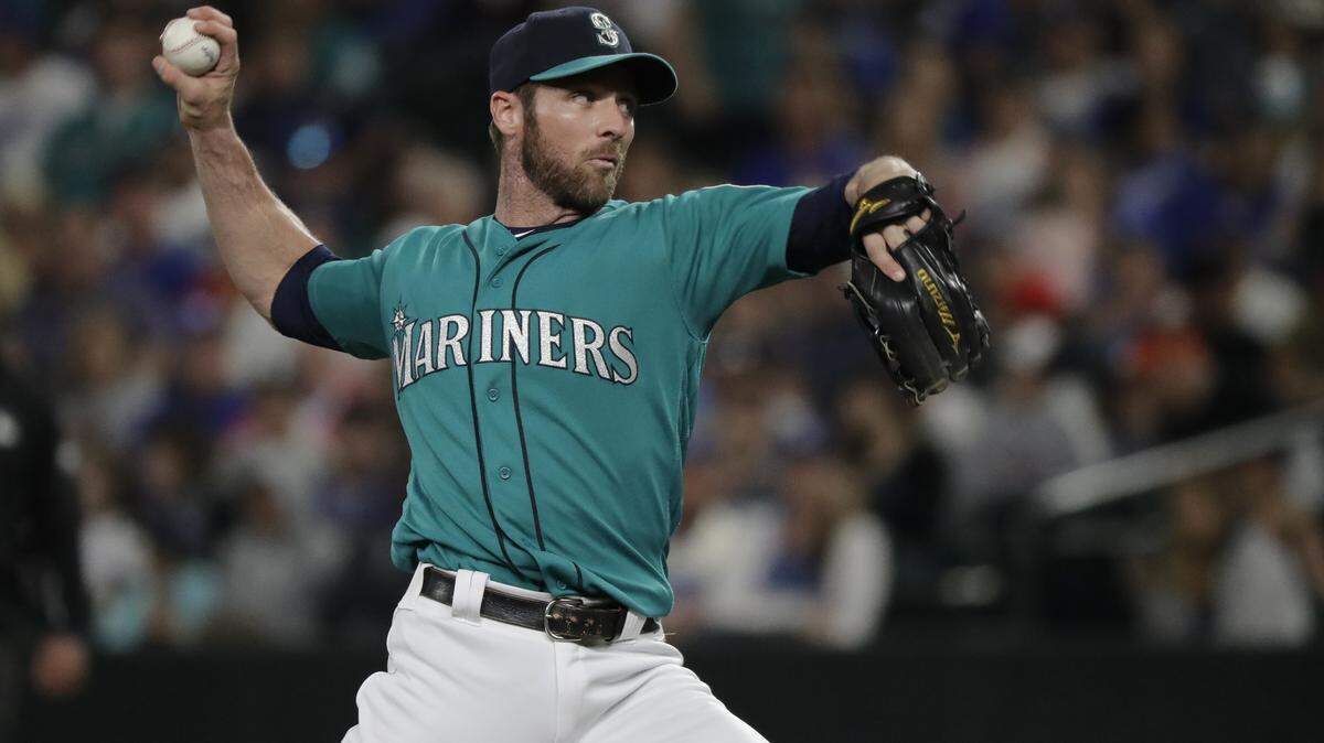 Seattle Mariners infielder Andrew Romine pitches against the Los Angeles Dodgers during the ninth inning of a baseball game Friday, Aug. 17, 2018, in Seattle. (AP Photo/Ted S. Warren)