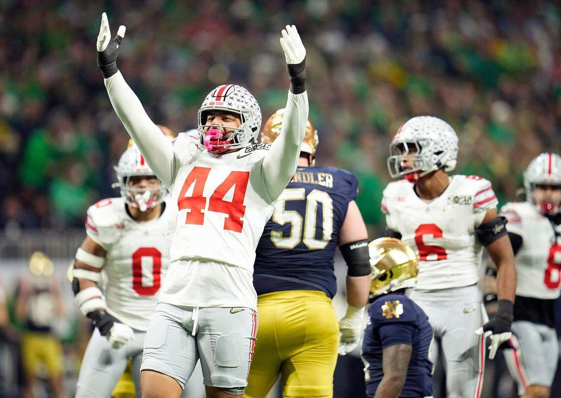 Ohio State Buckeyes defensive end JT Tuimoloau (44) celebrates a tackle of Notre Dame Fighting Irish running back Jeremiyah Love (4) in the first quarter during the College Football Playoff National Championship at Mercedes-Benz Stadium in Atlanta on January 20, 2025.