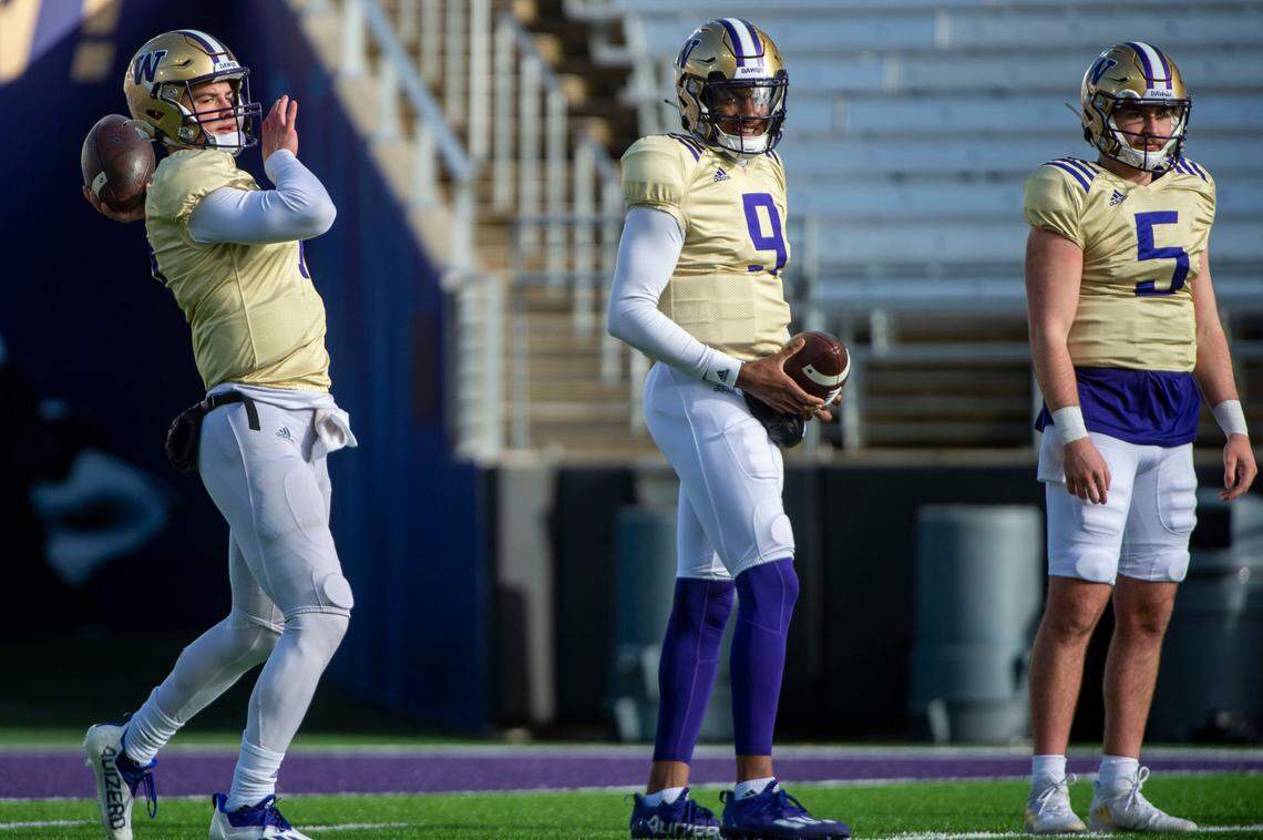 Washington quarterback Sam Huard attempts a pass as Michael Penix, Jr. (9) and Dylan Morris (5) watch during spring practice on Friday, April 8, 2022, at Husky Stadium in Seattle.