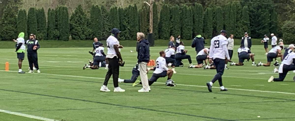 Wide receiver DK Metcalf (14, left) and coach Pete Carroll talk as Seahawks teammates begin practice without him participating on Oct. 9, 2023, in Renton. Metcalf has played through ribs he injured Sept. 17 in Seattle’s win at Detroit.