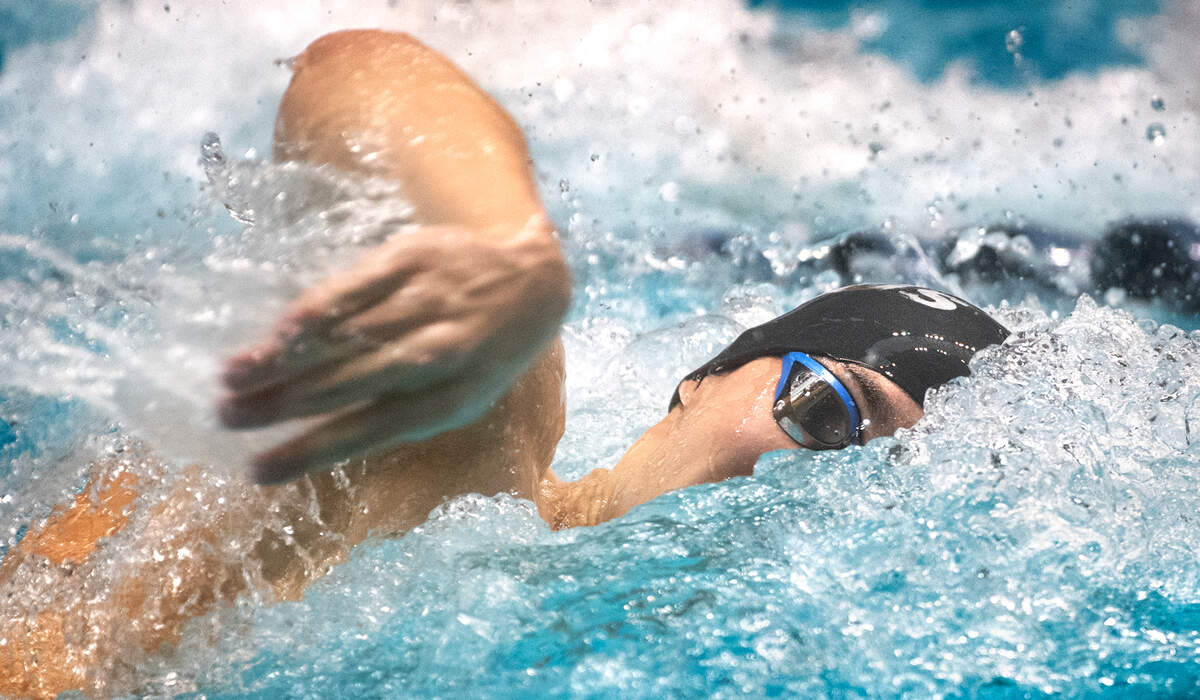 Curtis junior Tolu Young powers through the water en route to a second place finish in the 100-yard freestyle finals during the WIAA 4A Boys State Swimming and Diving Championships at the King County Aquatic Center in Federal Way, Washington, on Saturday, Feb. 18, 2023. Young added a state championship in the 50-yard freestyle earlier in the day.