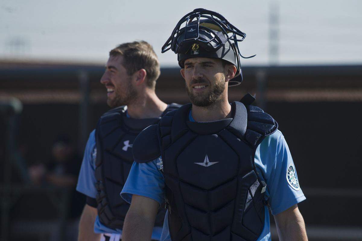 Seattle Mariners catchers Austin Nola (front) and Tom Murphy walk off the field after a drill at spring training on Tuesday, Feb. 18, 2020 in Peoria, Ariz.
