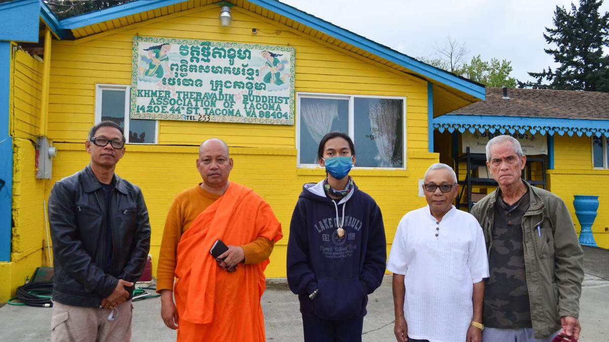 Temple leaders and temple-goers pose outside Khmer Theravadin Buddhist Temple in Tacoma where an elderly nun was attacked Sept. 21. From the left, Hoeurn Mon, assistant head monk; Chea Poeuv, head monk; Connar Mon, Hoeurn Mon’s son; Khoeun Khien, temple lay leader; and Victor Tang.