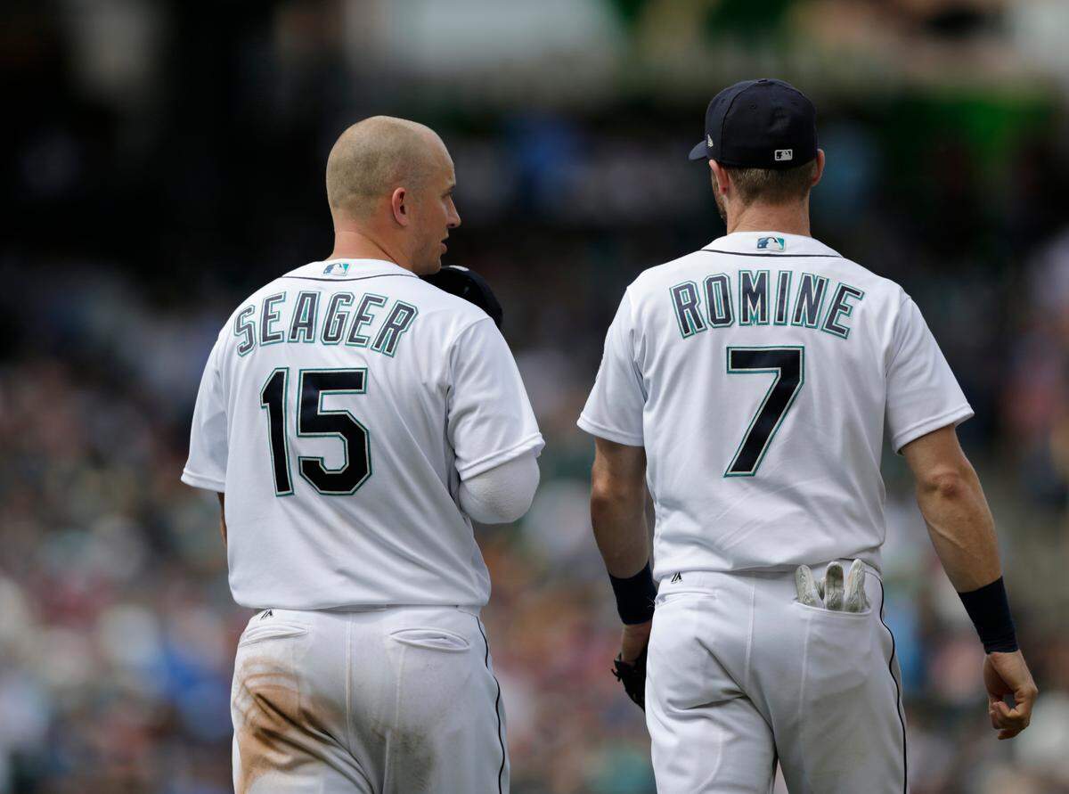 Seattle Mariners’ Kyle Seager and Andrew Romine talk as they walk on the field during a baseball game against the Colorado Rockies, Saturday, July 7, 2018, in Seattle. (AP Photo/John Froschauer)