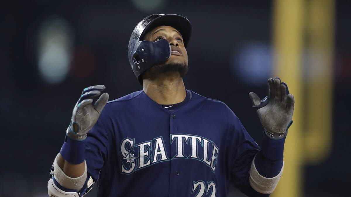 FILE - In this May 12, 2018, file photo, Seattle Mariners' Robinson Cano looks skyward as he crosses home plate after hitting a three-run home run during the fifth inning of the second baseball game of a doubleheader against the Detroit Tigers in Detroit. Cano has been suspended 80 games for violating baseball's joint drug agreement, the league announced Tuesday, May 15, 2018. (AP Photo/Carlos Osorio, File)