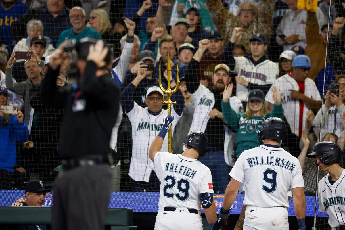 May 31, 2025; Seattle, Washington, USA; Seattle Mariners fans cheer as designated hitter Cal Raleigh (29) raises the home run trident following his two-run home run against the Minnesota Twins during the third inning at T-Mobile Park. Mandatory Credit: Joe Nicholson-Imagn Images