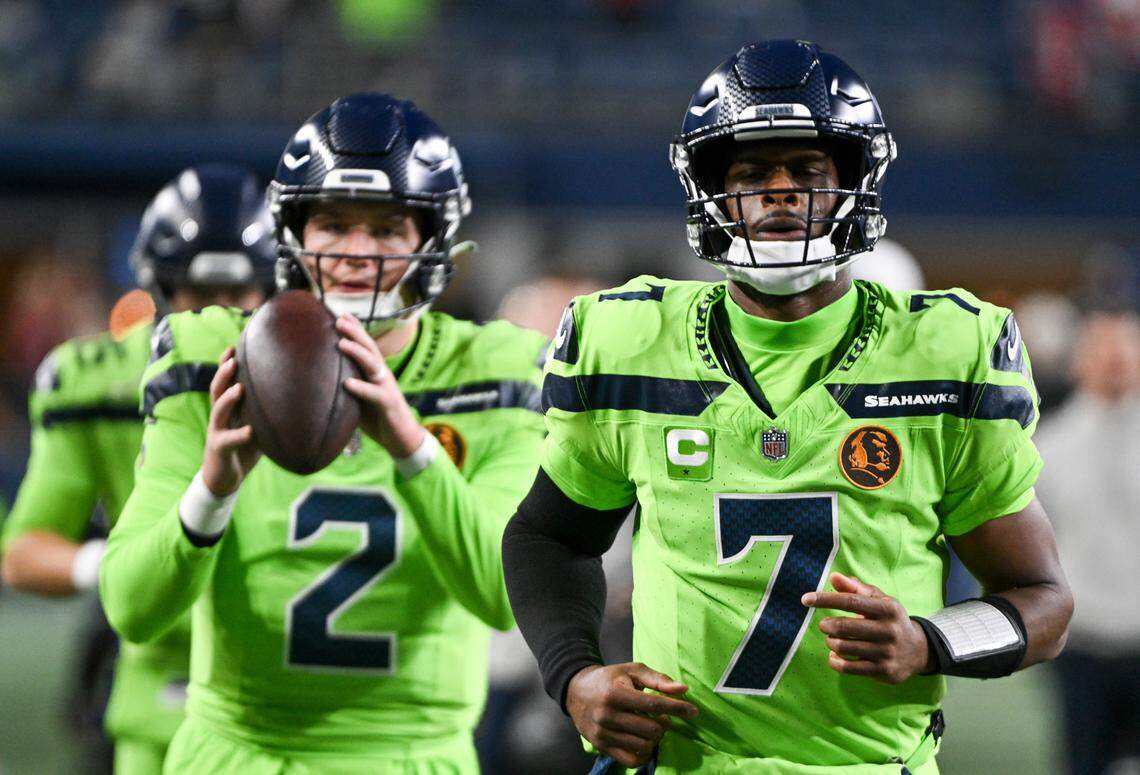 Seattle Seahawks quarterback Geno Smith (7) and quarterback Drew Lock (2) warm up before the game against the San Francisco 49ers at Lumen Field, Thursday, Nov. 23, 2023, in Seattle, Wash.