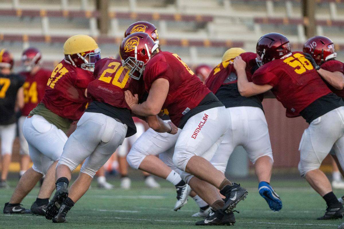 Enumclaw offensive lineman Zeke Luchi blocks a defender during team drills on Wednesday, Aug. 24, 2022, in Enumclaw, Wash.