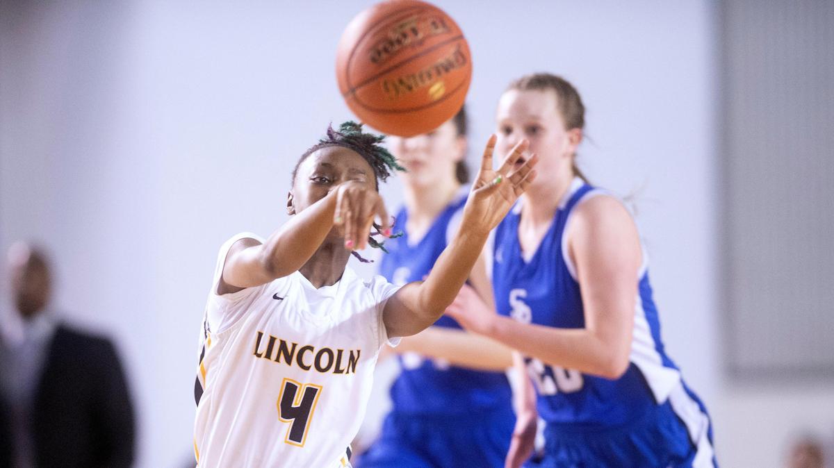 Lincoln’s Azriah Blackburn dishes off a pass as she pushes the ball upcourt during Wednesday evening’s opening-round game against the Seattle Prep Panthers in the WIAA 3A girls state basketball tournament in the Tacoma Dome on March 4, 2020.