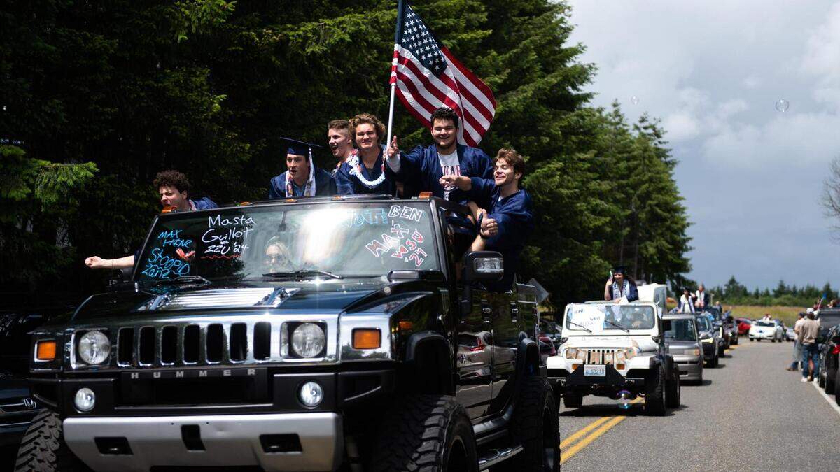 Gig Harbor graduates ride on a Hummer during a car parade at the Tacoma Narrows Airport. Peninsula and Gig Harbor High Schools held a celebratory car parade for graduates at the Tacoma Narrows Airport in Gig Harbor on Saturday. More pictures in an album at the bottom of this story.