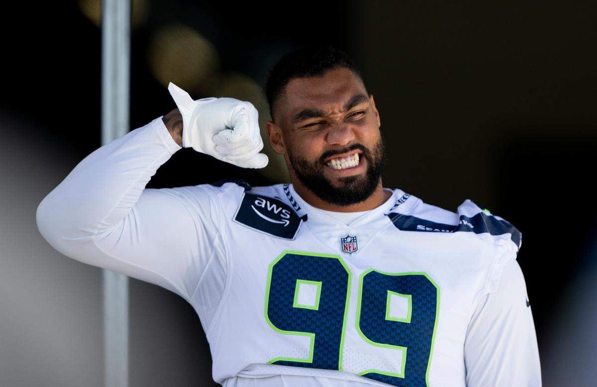 Seattle Seahawks defensive end Leonard Williams (99) greets fans during the first day of training camp at the Virginia Mason Athletic Center, on Wednesday, July 24, 2024, in Renton, Wash.