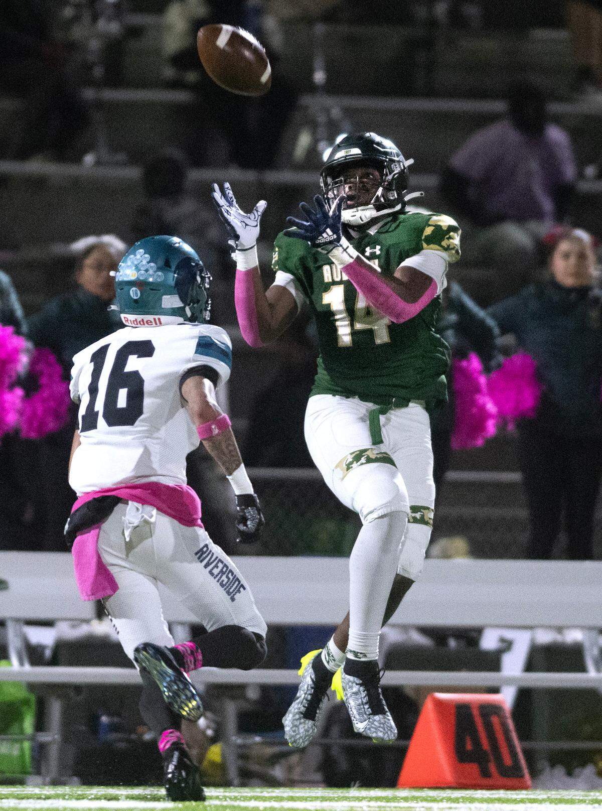 Auburn wide receiver Luvens Valcin pulls in a pass over Auburn Riverside defensive back Harlem Bejar during Friday night’s 3A NPSL championship game at Auburn Memorial Stadium in Auburn, Washington, on Oct. 27, 2023. Auburn Riverside won the game, 41-14.