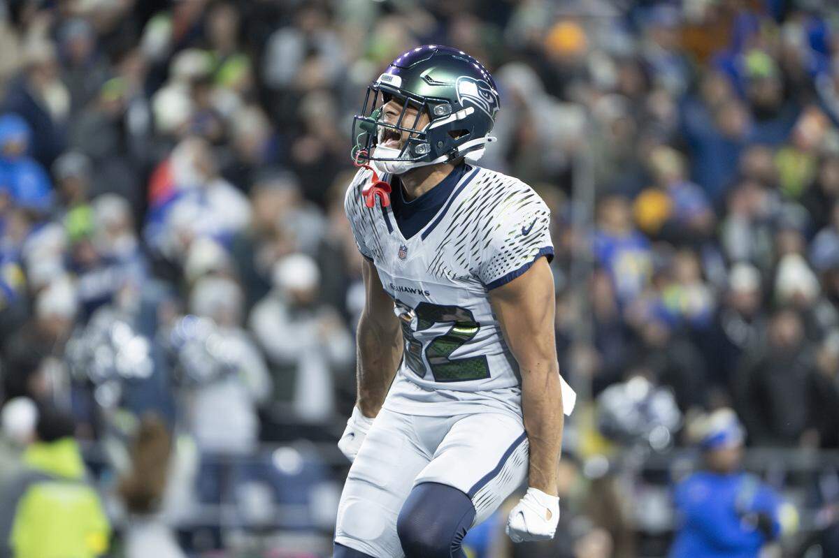 Seattle Seahawks wide receiver Cody White (82) hypes up the crowd as the Los Angeles Rams and Seahawks near overtime at Lumen Field, on Thursday, Dec. 18, 2025, in Seattle.