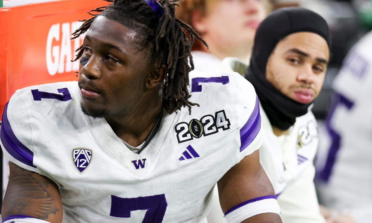 Washington Huskies running back Dillon Johnson (7) gets emotions in the closing moments of the Michigan Wolverines 34-13 victory in the College Football Playoff National Championship game at NRG Stadium on Monday, Jan. 8, 2024, in Houston.