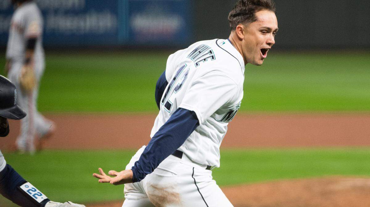 Seattle Mariners first baseman Evan White (12) celebrates after crossing the plate for the game-winning run after a Jake Fraley walk in the tenth inning. The Seattle Mariners played the San Francisco Giants in a Major League Baseball game at T-Mobile Park in Seattle, Wash., on Thursday, April 1, 2021.